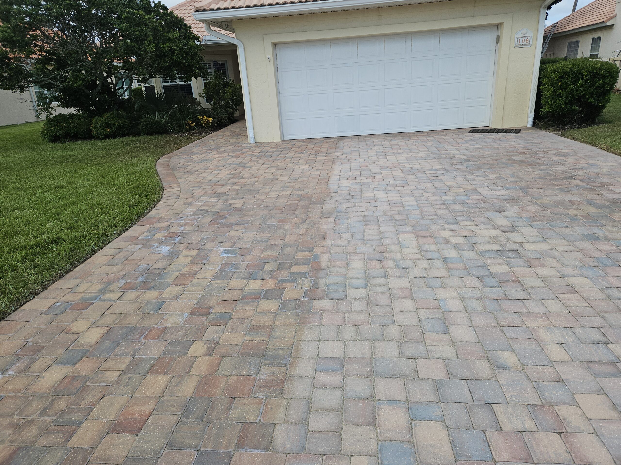 Paver sealing driveway before and after picture in St. Augustine, Florida.